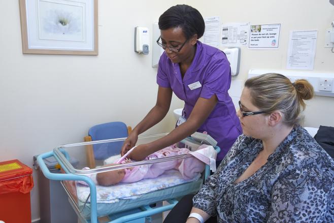 Midwife with mother and baby