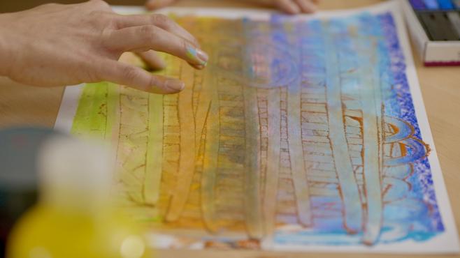 An image showing someone creating with chalk, depicting art therapy.