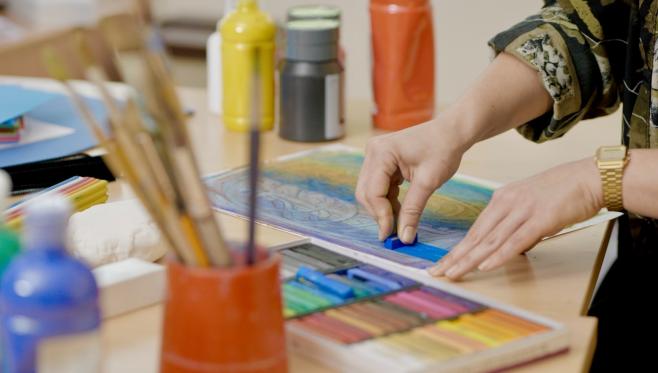 An image showing someone creating with chalk, depicting art therapy.